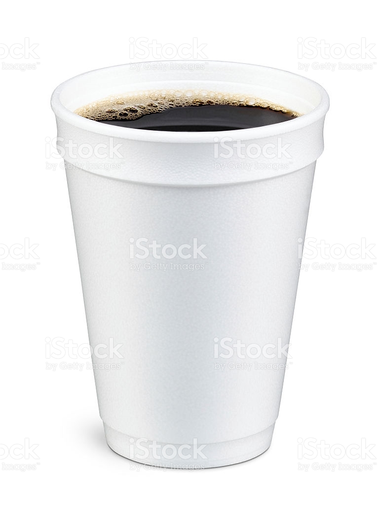 White foam cup containing coffee with bubbles on top