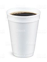 White foam cup containing coffee with bubbles on top